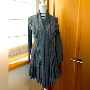 Grey cardigan sweater with unique design at bottom.
